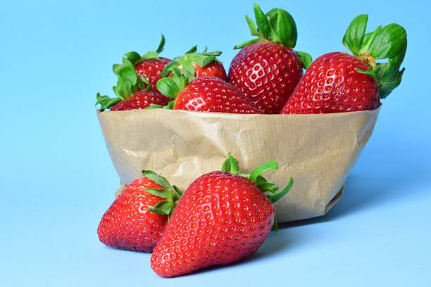 istock Fresh strawberries in a paper basket. 2216855898