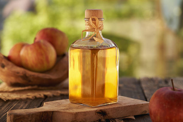 istock Apple cider vinegar in a glass bottle on a table 2216856143