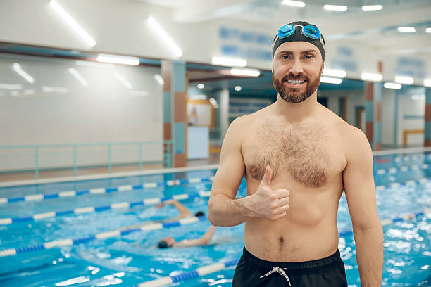 istock Man having a workout in the swimming pool 2216859745