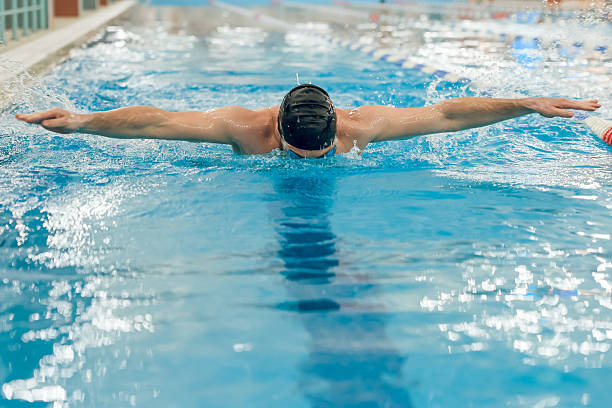 istock Man having a workout in the swimming pool 2216859893
