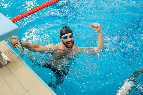 istock Man in swimming pool feeling excited and happy 2216859905