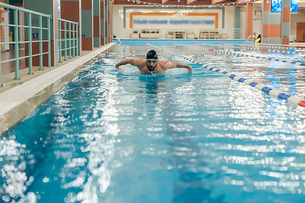 istock Man having a workout in the swimming pool 2216859910