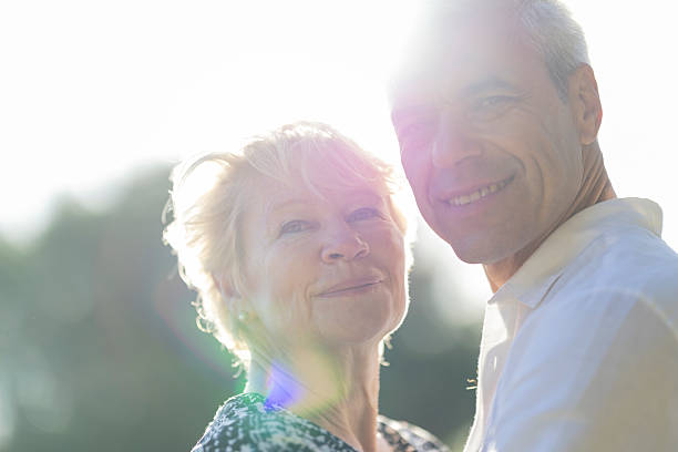 istock Happy senior couple smiling together outdoors in the sunlight 2216862871
