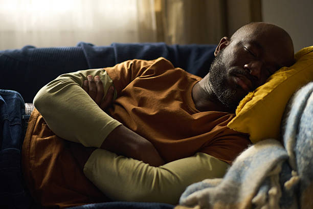 istock Sleeping African American Man on Comforting Sofa 2216863527
