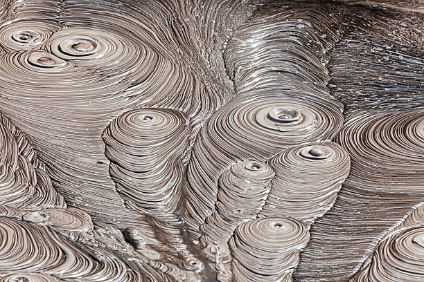 Close-up of geothermal mud pool showing textured bubbling layers near Rotorua in New Zealand.