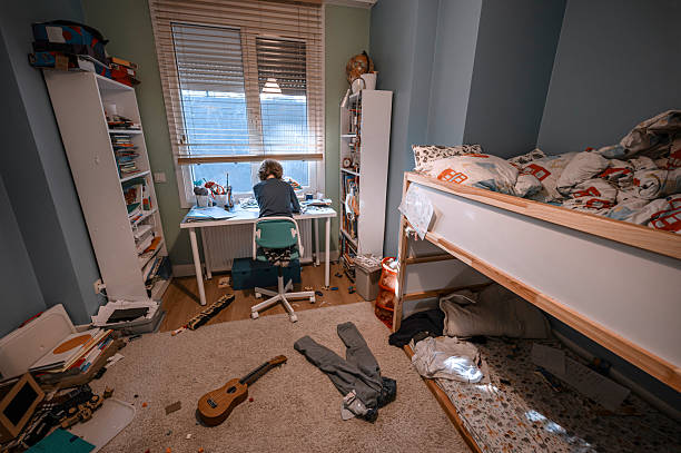 istock Child studying in messy bedroom with bunk bed and ukulele 2216863692