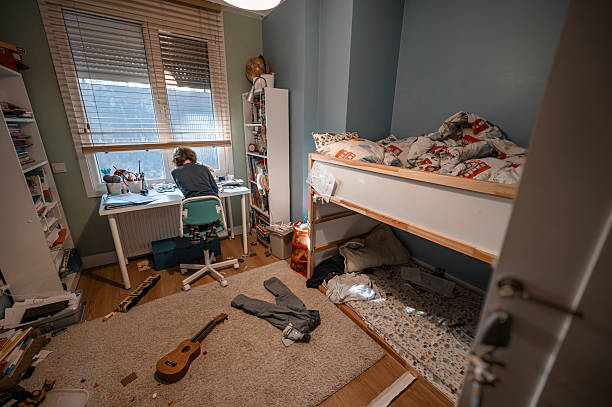 istock Child studying in messy bedroom with bunk bed and ukulele 2216863697