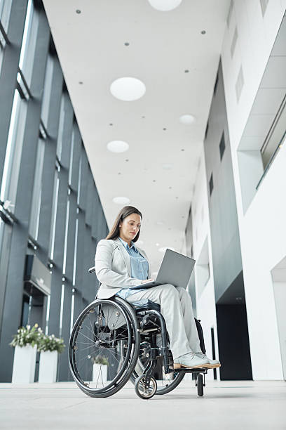 istock Young Businesswoman with Disability Using Laptop 2216866026