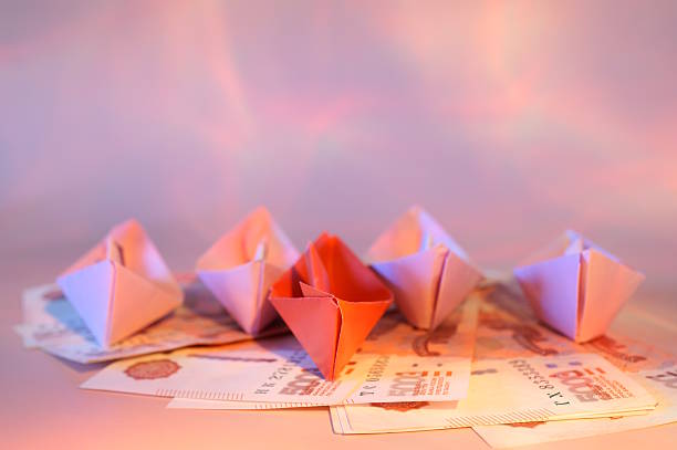 Conceptual money boat carrying question mark on money sea