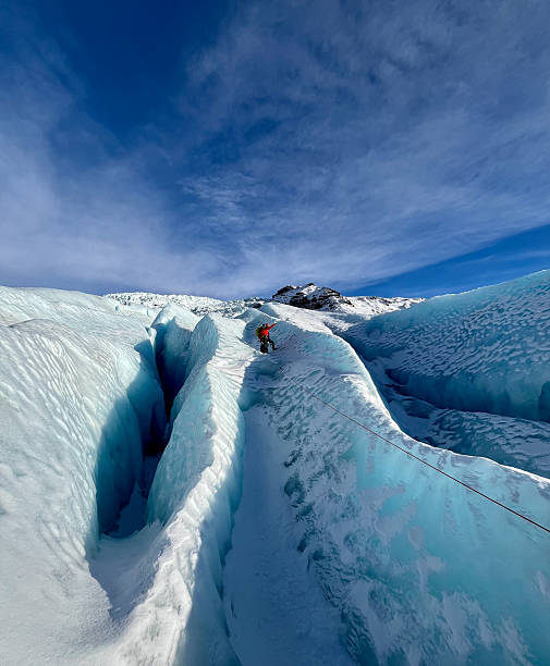 istock Ice climber in the middle of a massive glacier 2216876959