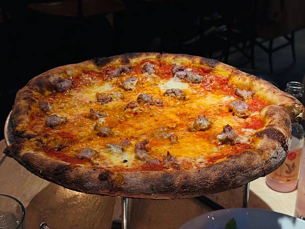 istock Freshly baked sausage pizza in a cozy restaurant 2216881278