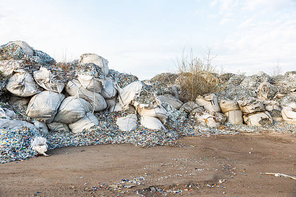 istock Plastic Waste in Industrial Sacks in Open Barren Area 2216886290