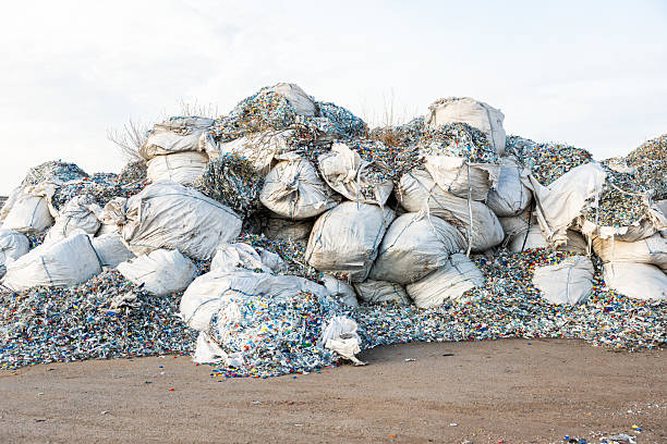 istock Large Piles of Plastic Waste in Oversized White Sacks on Dusty Ground 2216886291