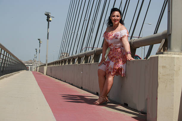 istock Modern mature woman on bridge in wind day 2216888529