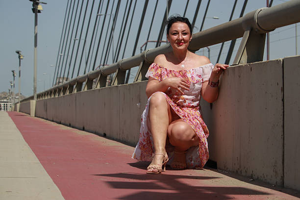 istock Modern mature woman on bridge in wind day 2216888535