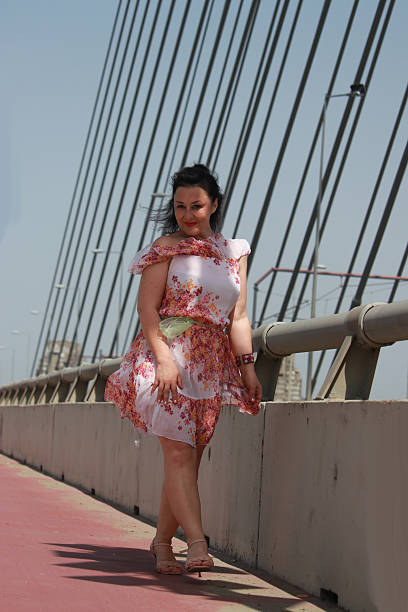 istock Modern mature woman on bridge in wind day 2216888555