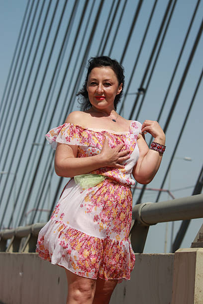 istock Modern mature woman on bridge in wind day 2216888565