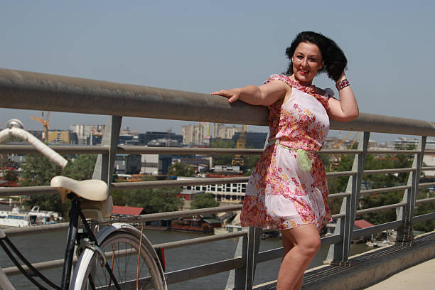 istock Modern mature woman on bridge in wind day 2216888575
