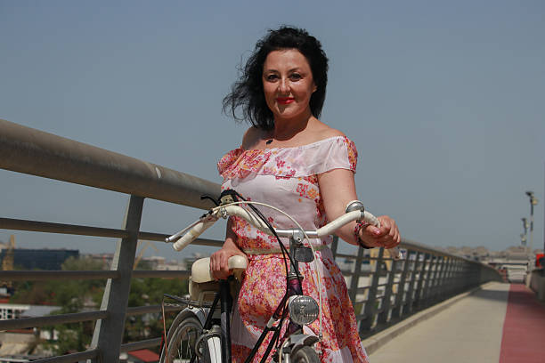 sunny day wind attractive dress bridge bicycle active lifestyle