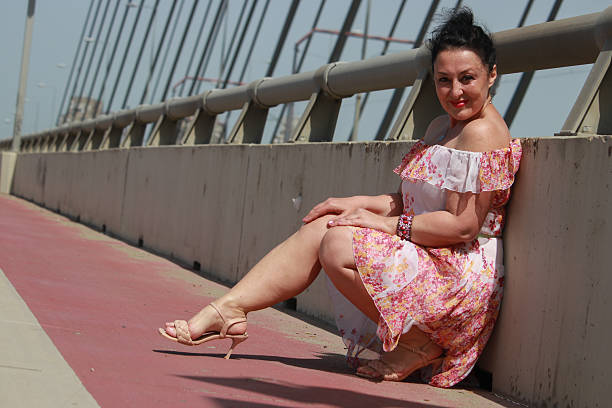 istock Modern mature woman on bridge in wind day 2216888949