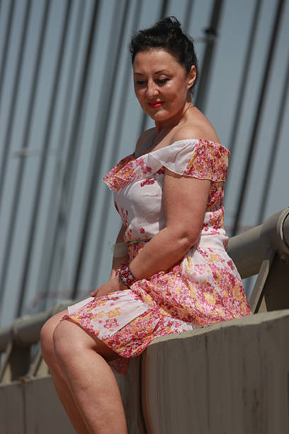 istock Modern mature woman on bridge in wind day 2216888965
