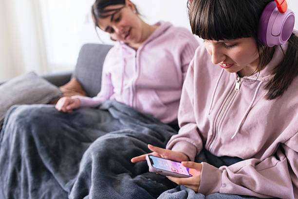 istock Teenage girl using smartphone with support worker beside her 2216890870