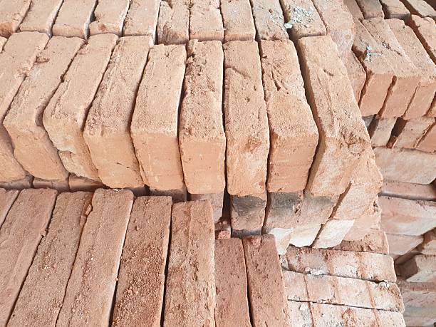 istock Neatly stacked red bricks with rough texture, ideal for construction, building material, or industrial-themed visuals and backgrounds 2216891161