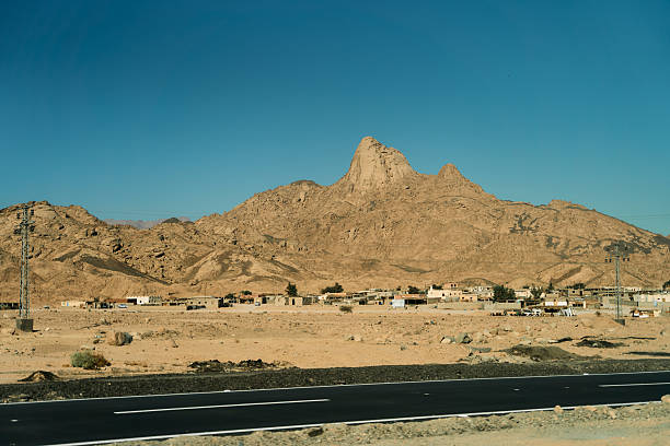 istock Expansive Desert Landscape Featuring Majestic Mountains and Abandoned Structures in Full View 2216894196