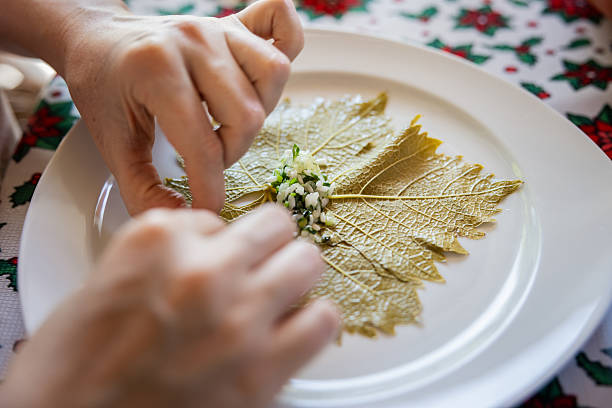 Unrecognizable woman is rolling Turkish sarma, dolma.Traditional Turkish cuisine.
