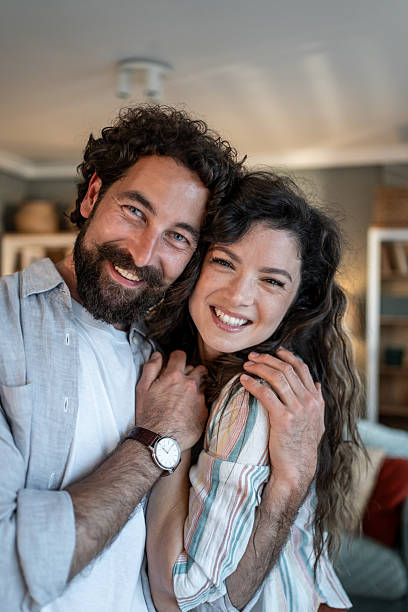 istock Happy couple embracing at home, showing love and affection 2216898220