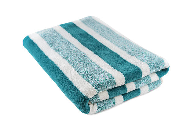 istock Carefully folded soft striped bath turquoise towel isolated on white background 2216901367