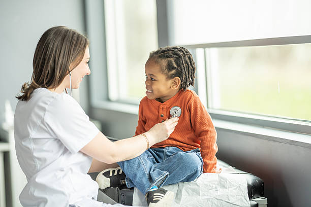 istock Smiling Kid During Check-up With Friendly Female Nurse in Modern Clinic 2216901446