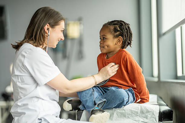 istock Smiling Kid During Check-up With Friendly Female Nurse in Modern Clinic 2216901450