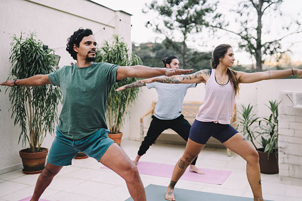 istock Group of friends practicing Yoga in the backyard 2216902649