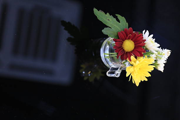 Flower vase on a reflective glass table