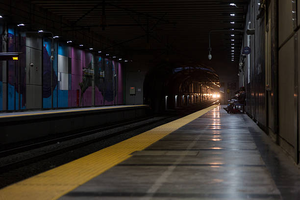 05/21/2025: Viña del Mar, Chile:A metro train heading toward Valparaiso arrives at the Miramar underground station (Viña del Mar), with lights on. People are waiting on the platform. ISO 1600