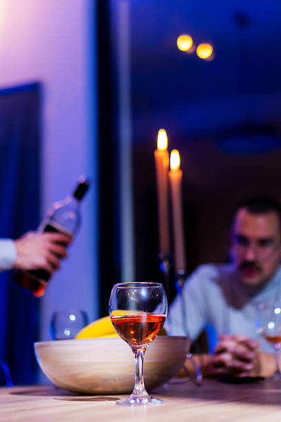 istock Cozy Evening with Candlelight, Glass of Wine, and Friendly Conversation at a Dinner Table 2216906927