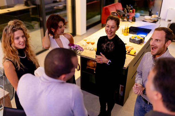 istock Friends socializing and enjoying a lively evening gathering in a modern kitchen setting 2216906945