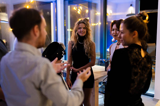 istock Group of stylish friends at a modern event, engaging in conversation 2216906951