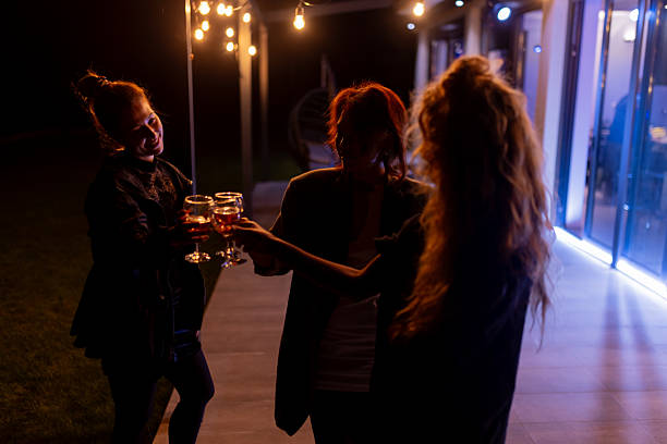 istock Friends Toasting with Drinks During a Nighttime Gathering Outdoors 2216906983