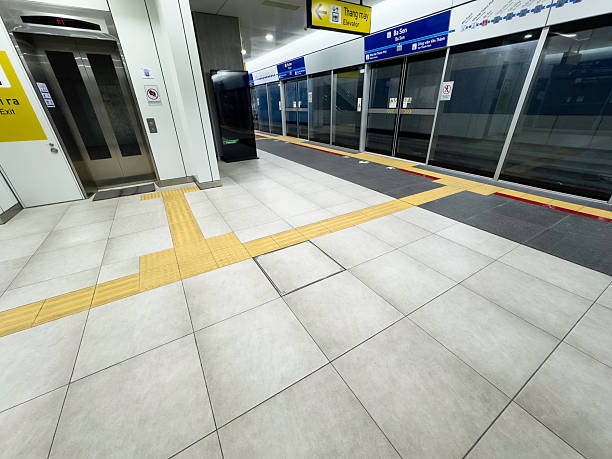 Accessible tactile pavement inside a Ho Cho Minh City Subway station, from elevator to the platform