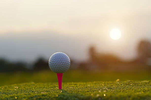 istock Close-up golf ball on tee with blur green bokeh background. 2216913151