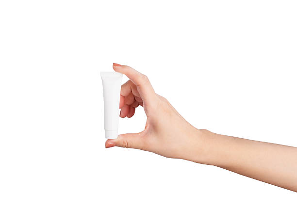 istock Female hand holding blank cosmetic bottle isolated on white background, clipping path. 2216914894