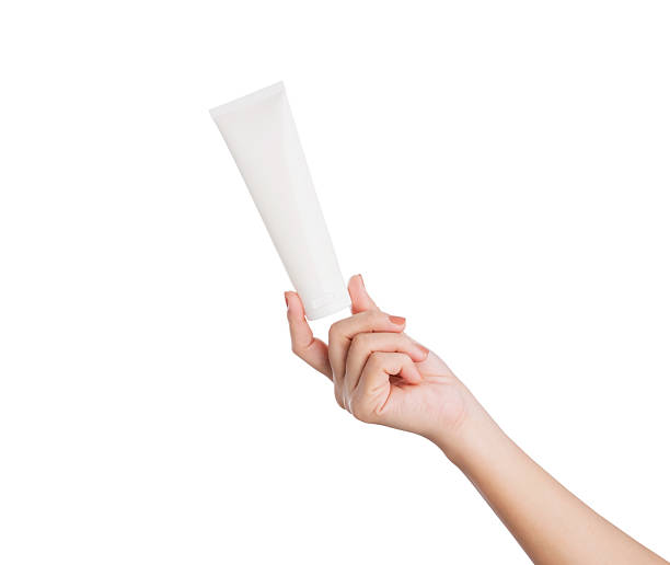 istock Female hand holding blank cosmetic bottle isolated on white background, clipping path. 2216914896
