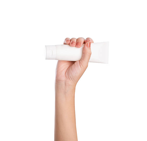 istock Female hand holding blank cosmetic bottle isolated on white background, clipping path. 2216914908
