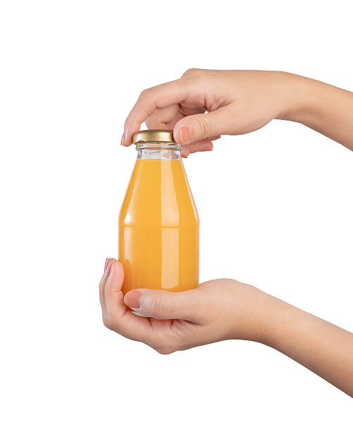 istock Hand holding bottle of orange juice, clipping path. 2216915018