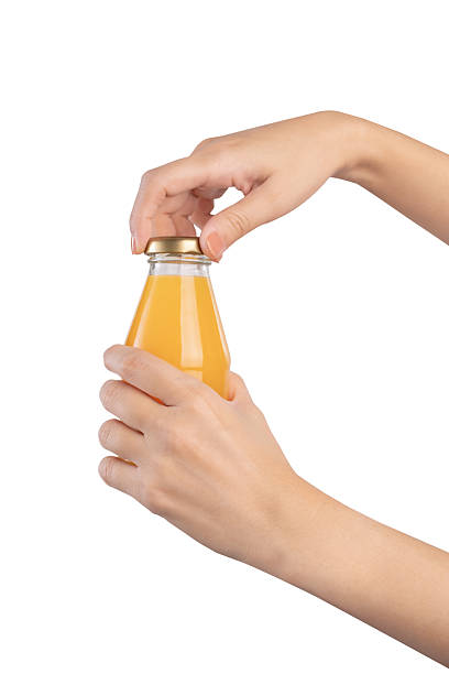 istock Hand holding bottle of orange juice, clipping path. 2216915541