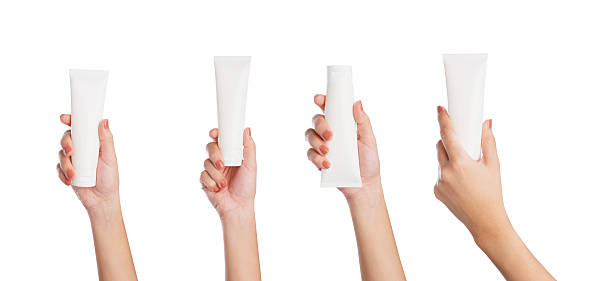 istock Female hand holding blank cosmetic bottle isolated on white background, clipping path 2216915595