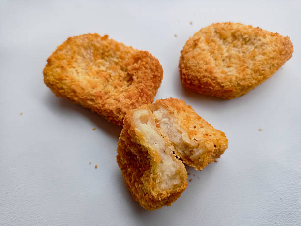 istock Appetizing fried chicken nuggets arranged neatly against a pure white background. 2216915864