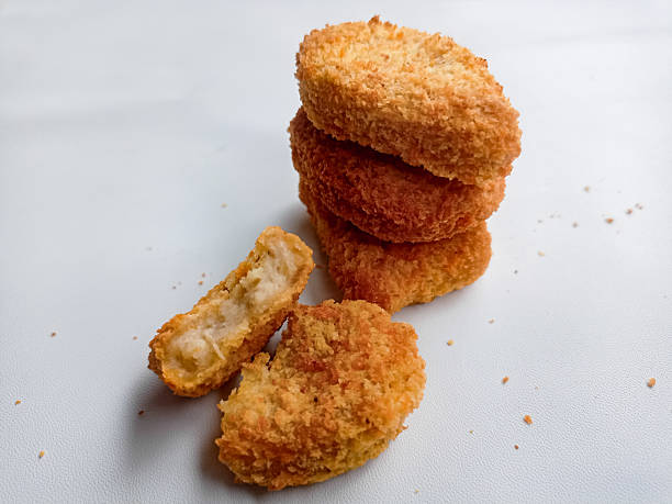 istock Appetizing fried chicken nuggets arranged neatly against a pure white background. 2216915888